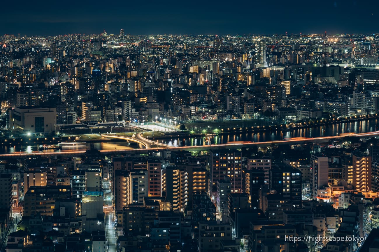 Sakura Bridge illuminated over the Sumida River.