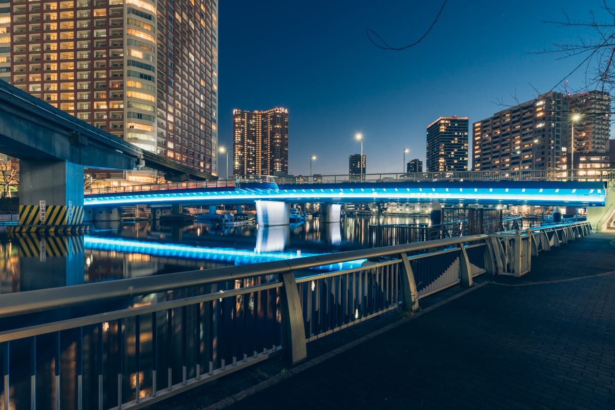 Shore bridge illuminated in blue.