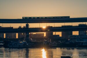Morning sun and trains running on the Yurikamome Line.